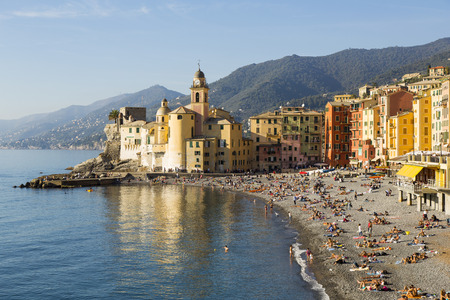 Panoramic view of a seaside town in the foreground beach an church in the background on a sunny dayのeditorial素材
