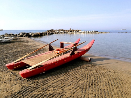 Close up view of a rescue coat of a beach with cliff in the background on a summer dayの素材