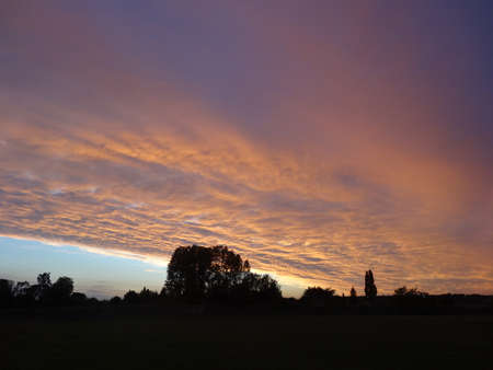 Sunset over the village of St. Mary's Church, Kent, UKの写真素材
