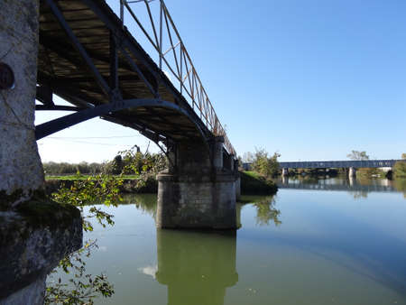 A view of a bridge over a river in the countryside in Franceの写真素材