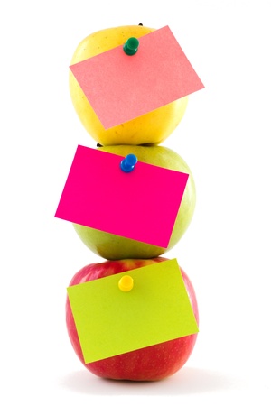 Vertical composition of three colourful apples with bright colour stickers, isolated on white backgroundの写真素材