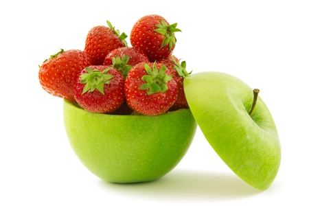 Green apple filled with ripe strawberriesの写真素材