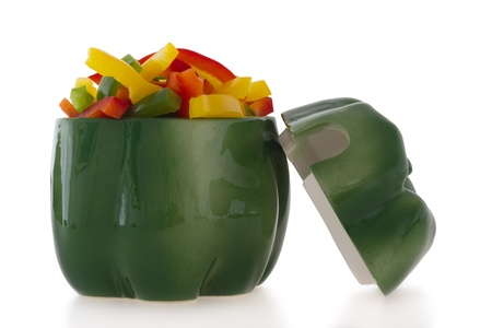 Ceramic green pepper shaped ornament filled with cut colofrul bell pepper slices.の写真素材