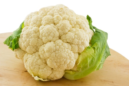 Whole Cauliflower on wooden board,  isolated on white の写真素材