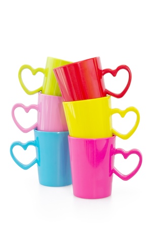Two Stacks of colorful cups with heart element isolated on white background の写真素材