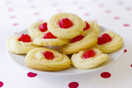 Home made cookies on red polka pot background の写真素材