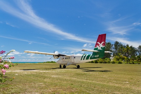 Small domestic tropical airplane of Air Seychelles, just landed on grass fieldのeditorial素材
