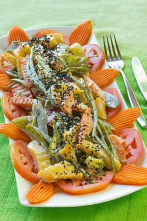 Fresh vegetable salad with carrot, green peas, tomato, beans, potato and sesame seeds の写真素材