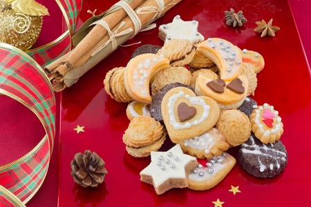 Christmas cookies, short bread in different shapes, with spices, festive red background の写真素材