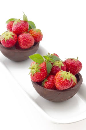 Hand made chocolate cup filled with fresh strawberry isolated on a white backgroundの写真素材