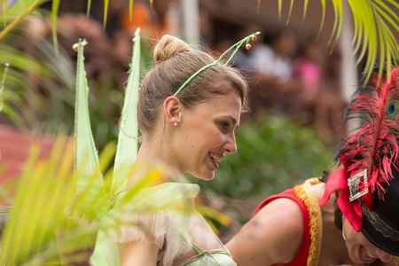 Victoria, Seychelles - February 9, 2013:  A young Caucasian women wearing green butterfly outfit performing on streets of Victoria, on Parade of Seychelles international Carnivalのeditorial素材