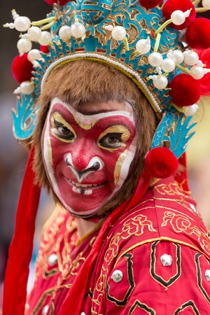 Victoria, Seychelles - February 9, 2013:  Group of Chinese people with traditional festive dresses as a manky  performing on streets of Victoria, on Parade of Seychelles international Carnivalのeditorial素材