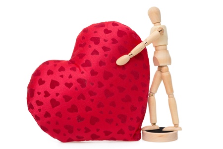 Wooden mannequin holding gigantic soft red heartの写真素材