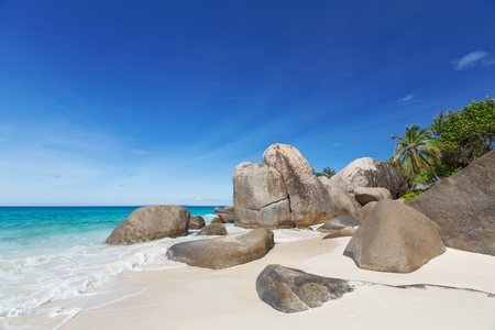 Seascape with large granite boulders and blue summer sky  Carana beach view of Seychellesの写真素材