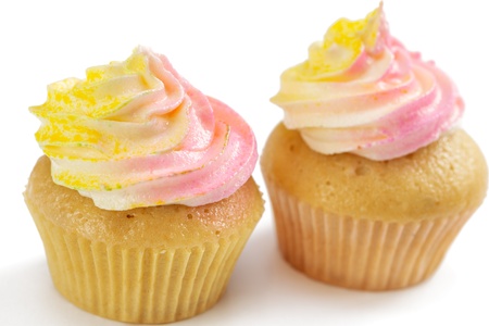 Two pink and yellow cupcake, isolated on white backgroundの写真素材