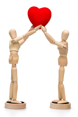 Two wooden dolls  mannequins holding red heart isolated over a white backgroundの写真素材