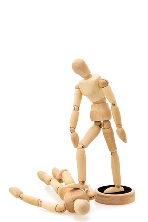 Concept of winner and beaten  one wooden mannequin   doll standing over lying dollの写真素材
