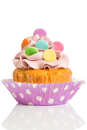 Homemade cupcake with colorful decoration isolated on white backgroundの写真素材