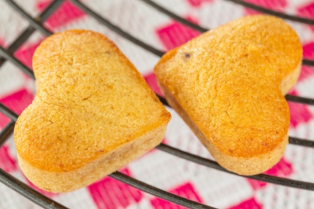 Two Homemade heart shaped banana muffins cooling on metal rackの写真素材
