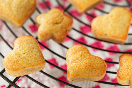 Homemade heart shaped banana muffins cooling on metal rackの写真素材