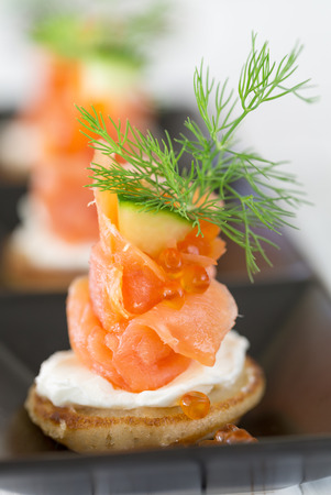Blini with smoked salmon and sour cream, garnished with dill  Close-up viewの写真素材