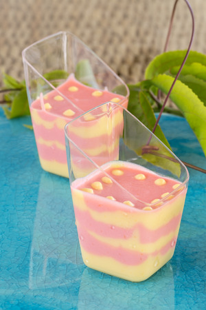 Passion fruit and strawberry mousse  on blue plateの写真素材