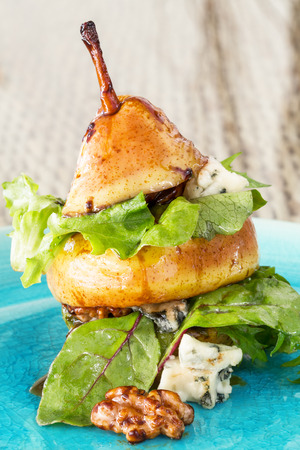 Original way to serve pear salad with green leafs, blue cheese and walnutsの写真素材