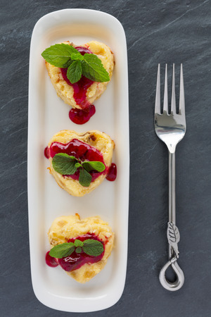 Vertical composition of Cottage-cheese Baked Pudding in heart shape with forkの写真素材