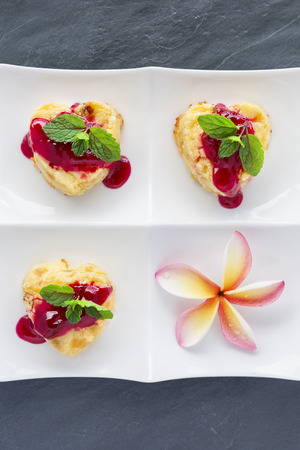 Cottage-cheese Baked Pudding ins heart shape with frangipani flowersの写真素材