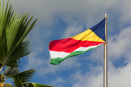 Seychelles waving flag on blue sky backgroundの写真素材