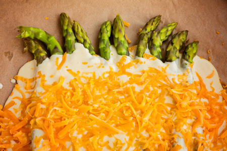 Creamy baked asparagus and aged cheddar redy for ovenの写真素材