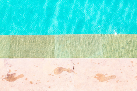 Wet foot prints on side of swimming pool の写真素材