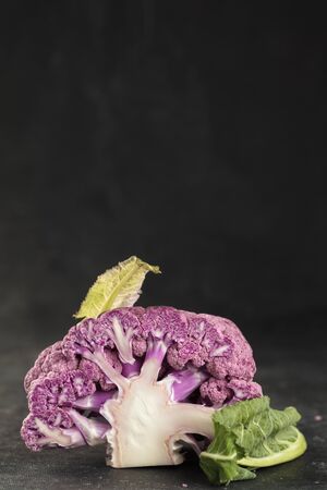 Cross cut of Fresh purple cauliflower on dark background , vertical composition, copy space の写真素材
