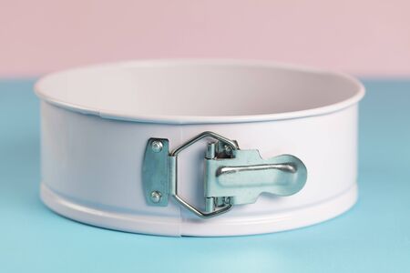 Pink metal backing cake ring on blue and pink background