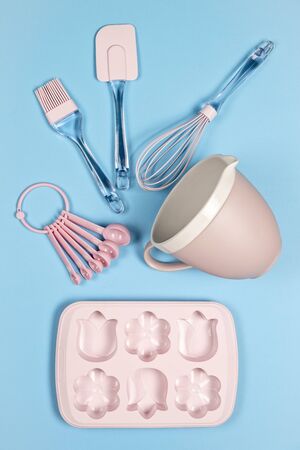 Pink kitchen backing utensils on blue background, top viewの写真素材