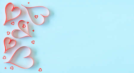 Hang made red paper hears on blue background