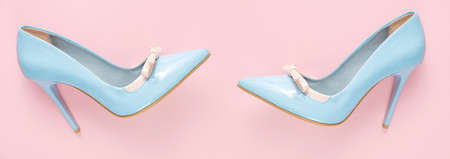 Pare of blue shiny high heel shoes on pink background, flat lay, bannerの写真素材