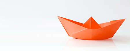 Red paper boat isolated on white background, banner with copy spaceの写真素材