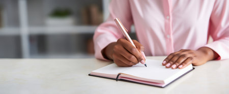Femail in pink close person journaling or writing in a diary, emphasizing the practice of self-reflection and emotional processingの素材