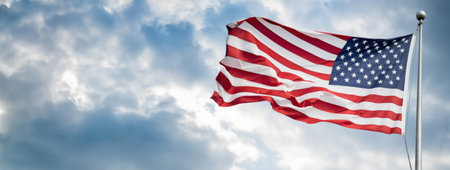 American flag waving proudly against a blue sky, representing patriotism, freedom, and national pride, free copy space .の素材
