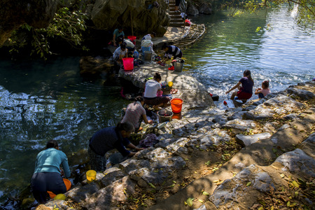 Villagers washing laundry at the riverのeditorial素材