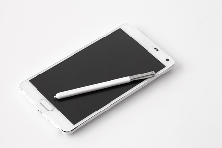 smartphone with pen on white の写真素材