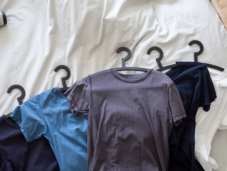 clothes housework household messy on bed wait for laundry and hanging in cupboardの写真素材