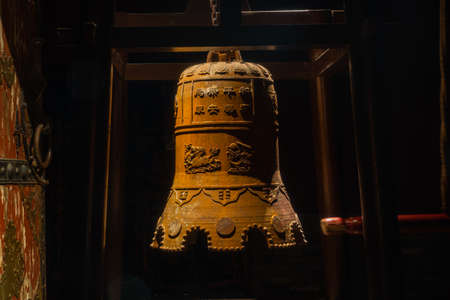 Bronze bell hanging in a Buddhist templeの写真素材