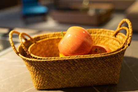 Woven fruit basket orange apple fruitの写真素材