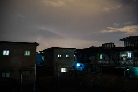 Lightning dark clouds in the night sky in the countrysideの写真素材