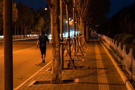 Pedestrians on the street at nightの写真素材