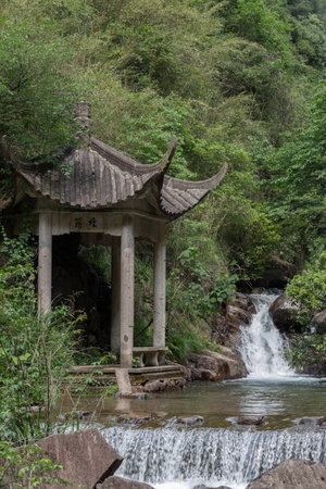 Waterfall and pavilion in the Daqi Mountain Park, Hangzhou, China.の写真素材