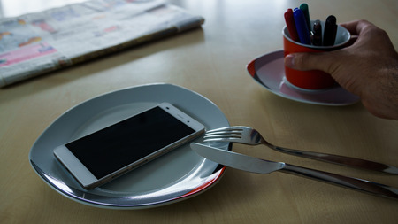 Person drinking a Cup of Pens for Breakfastの写真素材