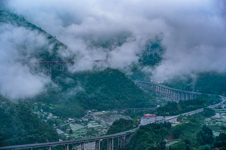 Clouds and mist around the mountainsの写真素材